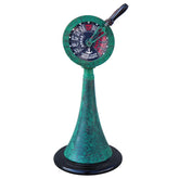 A brass patina engine order telegraph with a handle and a face indicating maritime signals, in a vintage green finish.